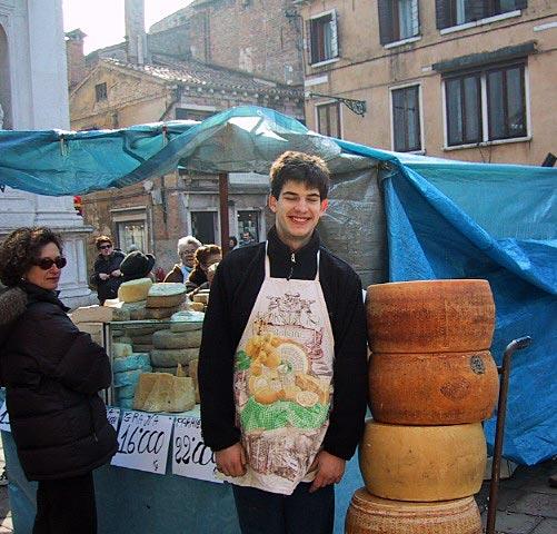 A Venetian cheese merchant making a silly grin for the camera.