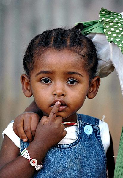 A cute kid posing for a photo in Arba Minch