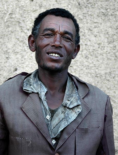 This guy in his pin-stripe suit was crying as he begged me for money, but perhaps it was just an act.  The moment that I took out my camera to photograph someone else, he jumped in front and almost smiled.